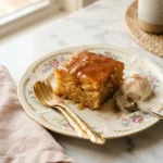 Golden sol agave butter cake slice soaked in warm agave-butter glaze on a floral plate