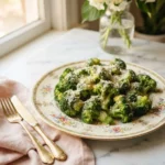 Texas roadhouse broccoli recipe with bright green florets tossed in garlic butter and parmesan on a floral plate